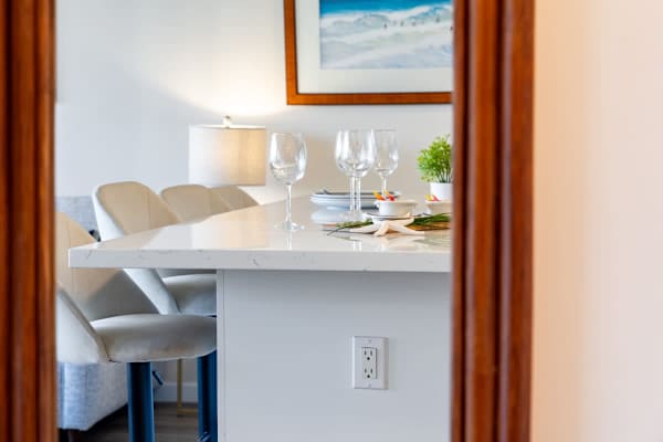 modern kitchen island with seating and tableware set for dining