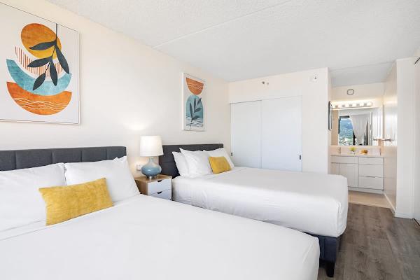 Bright bedroom with two queen beds and modern decor