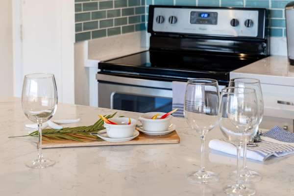 Modern kitchen with a marble countertop and stainless steel stove
