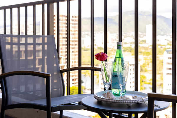 Relax on the balcony with city and mountain views and a refreshing drink.