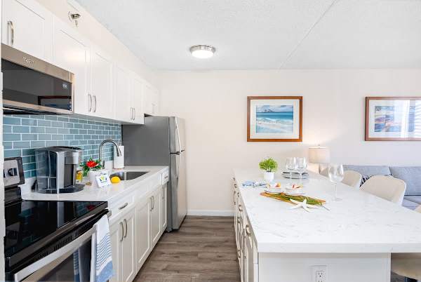 Modern kitchen with a large marble island and stainless steel appliances