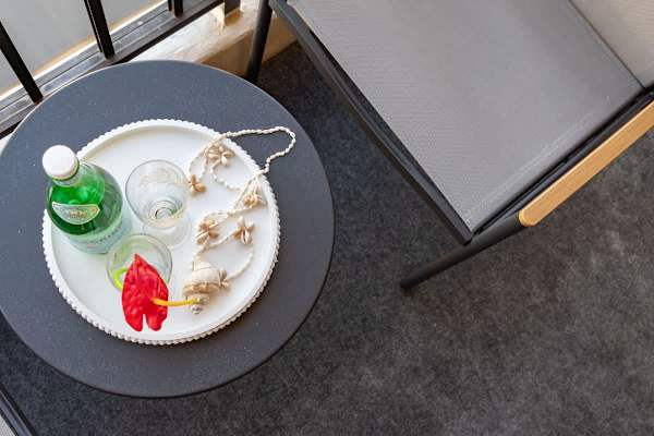 Relax on the balcony with a refreshing drink and modern outdoor seating.
