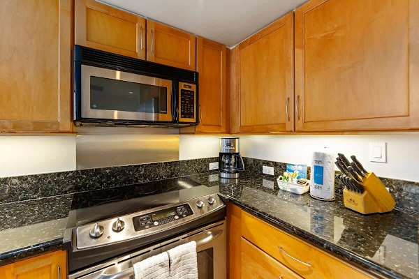 Kitchen with dishwasher, oven, stove, fridge and microwave