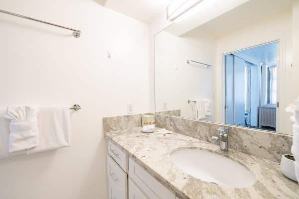 The bathroom has a vanity with cabinet!