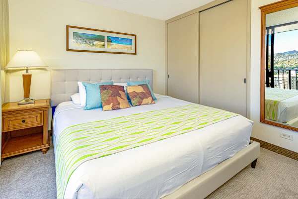 Bright bedroom with a king-size bed and balcony view