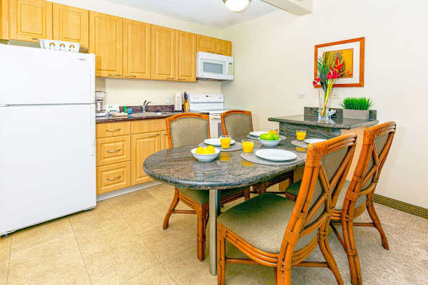 Compact kitchen with granite dining table and seating for four.