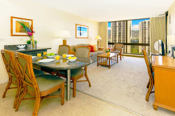 Bright living and dining area with large windows offering city views.