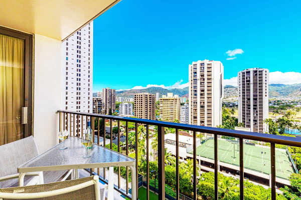 Relax on the balcony with views of the city skyline and tennis courts.