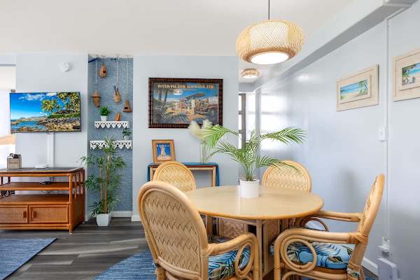 Gather for meals around the charming circular dining table with 4 tropical-inspired chairs, perfectly set for delightful dining and enjoying the unit's island ambiance.
