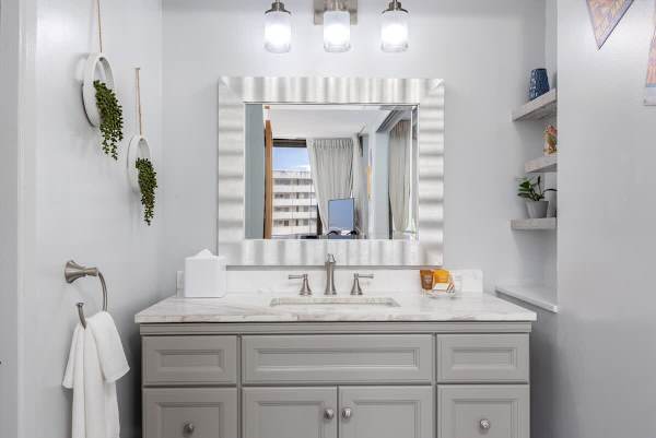 Step into a bright and stylish bathroom featuring a spacious vanity with a marble countertop, perfect for your morning routine.