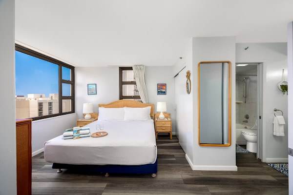 Experience ultimate comfort in this inviting bedroom featuring a king-size bed and convenient access to a modern en-suite bathroom.