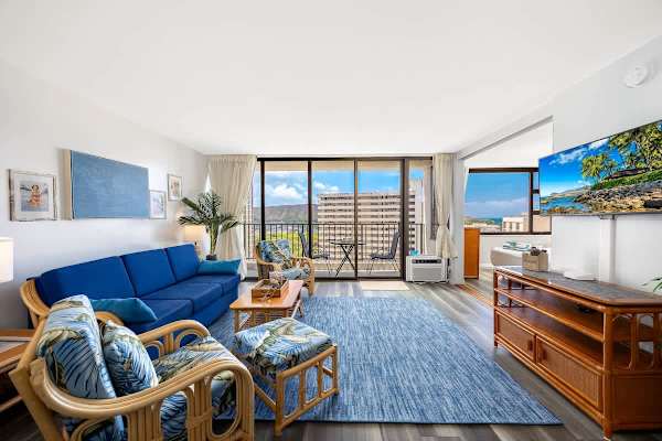 Unwind in this spacious and bright living area, offering a queen-size pull-out sleeper sofa, charming tropical-themed seating, a 43" Smart TV, and direct balcony access with stunning views.