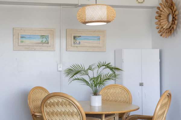 Gather around our charming dining area, featuring a tropical-inspired table and chairs, perfect for enjoying meals or planning your daily adventures.
