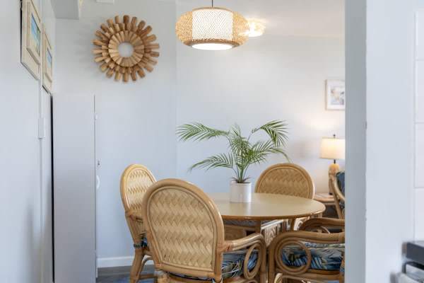 Gather around our charming dining area, featuring a tropical-inspired table and chairs, perfect for enjoying meals or planning your daily adventures.