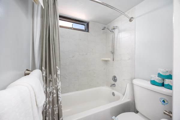 Escape to comfort and convenience in your bathroom featuring a refreshing shower and tub, ready for your relaxation.