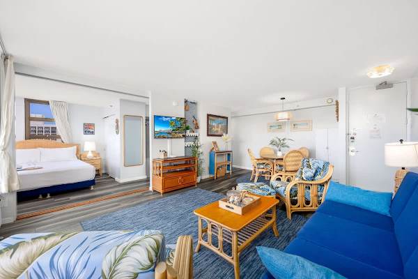 Step into this bright living area, which features a 43" Smart TV, pull-out sleeper sofa, a coffee table, and 2 comfortable chairs.
