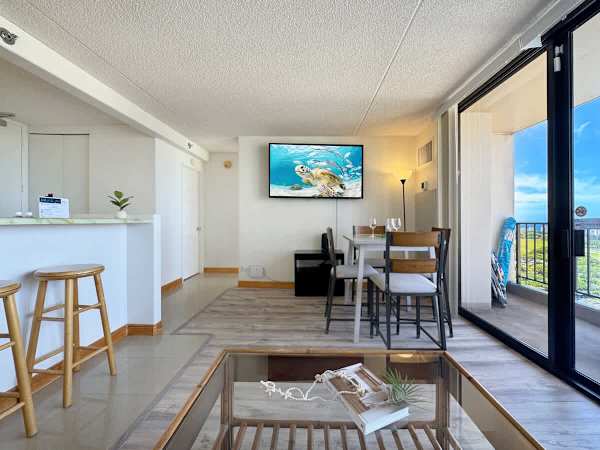 Relax, dine, or simply take in the view from this spacious living area with direct access to the balcony.