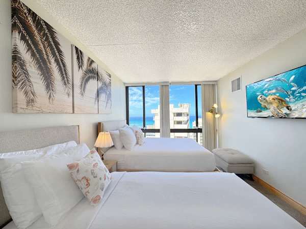 Drift to sleep in your bedroom with a queen and a twin-size bed, a 50" Smart TV, and wake up to a stunning ocean view right from your window.