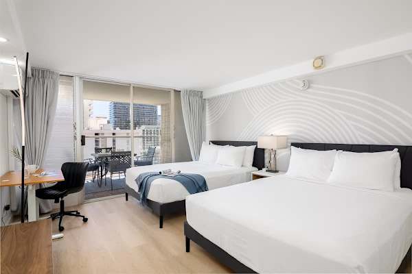 Relax in this bright and modern studio with two queen beds, split AC, a private balcony, and a dedicated workspace.