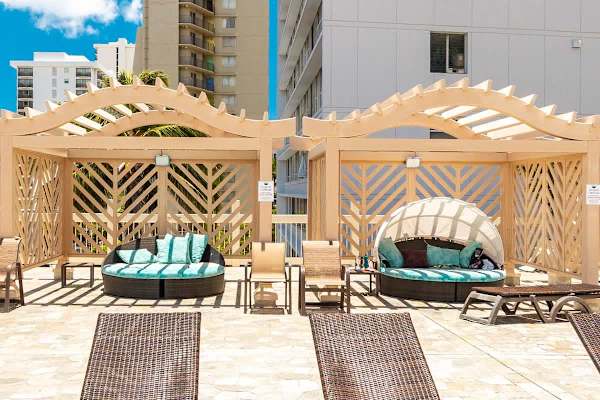 There are 4 daybed cabanas next to the pool