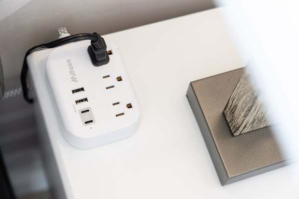 The bedroom area has a power strip with multiple outlets and USB ports, conveniently placed for charging your devices.