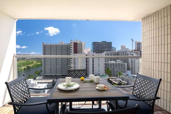 Relax and enjoy a meal with a view of the city skyline and Ala Wai Canal from your private balcony.