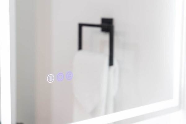 A modern bathroom mirror with built-in touch controls.