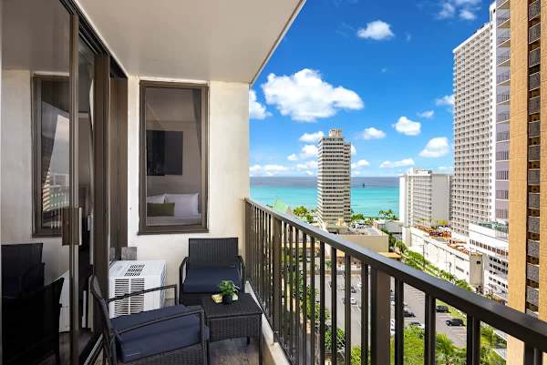 Relax on the private balcony with comfortable seating and enjoy the impressive, straight-on views of the sparkling blue ocean and city skyline.