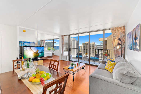 Bright living area with city and ocean views from the balcony