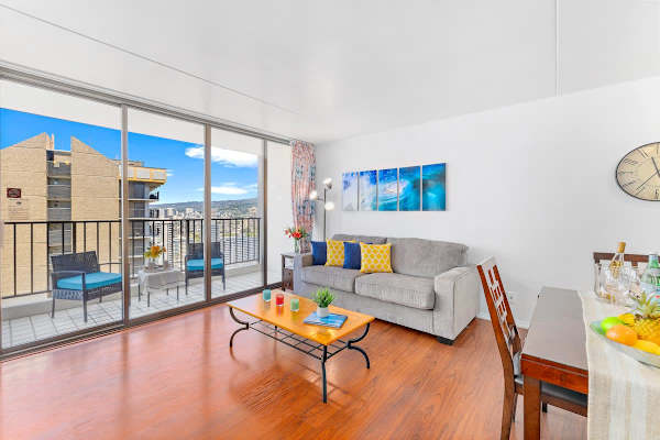 Bright living room with balcony seating and city views