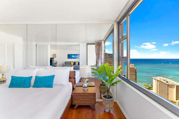 Bright bedroom with ocean views and modern decor.