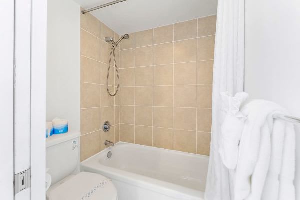 Clean bathroom with a tiled shower and bathtub combination.
