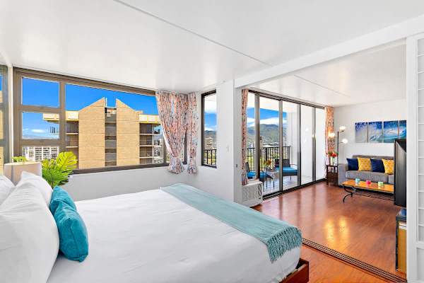 Bright studio with city views and a balcony seating area