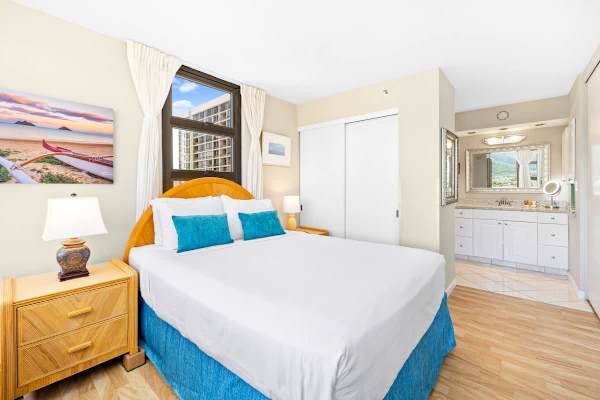 Bedroom with queen-size bed comes with closet and dresser for clothing storage