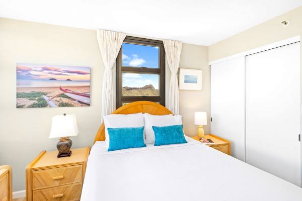 Bedroom with queen-size bed comes with closet and dresser for clothing storage