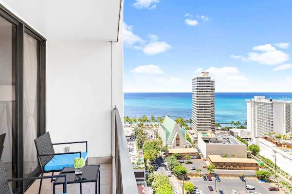 Step onto your private balcony for a dazzling, high-rise view of a vibrant city skyline and the stunning blue waters of the Pacific Ocean.