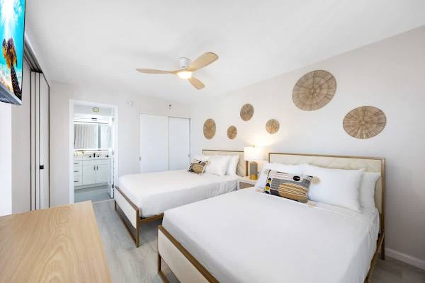 Enjoy a seamless stay in your bright bedroom, which features a queen and a full bed, plus quick, easy access to your bathroom.