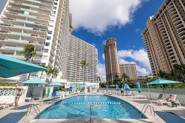 Soak up the sun beside the sparkling, resort-style pool, framed by swaying palms and towering Waikiki skylines for the perfect tropical escape