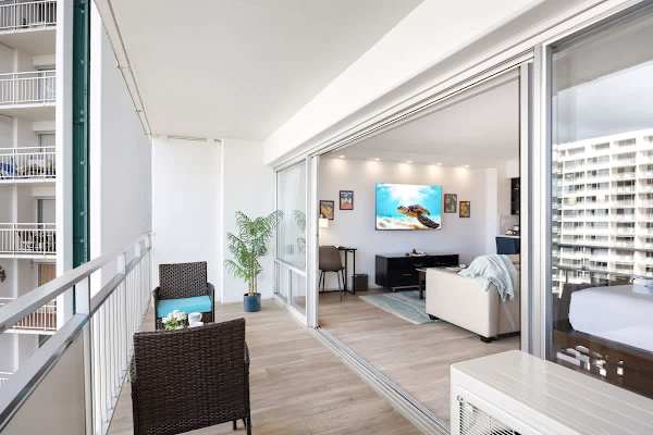 Your balcony has a woven rattan seating and direct sliding glass door access to your open-plan studio interior.