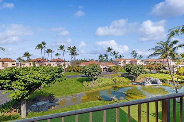 Elevated Balcony View Overlooking Resort Lawns, Palm Trees & Scenic Water Feature