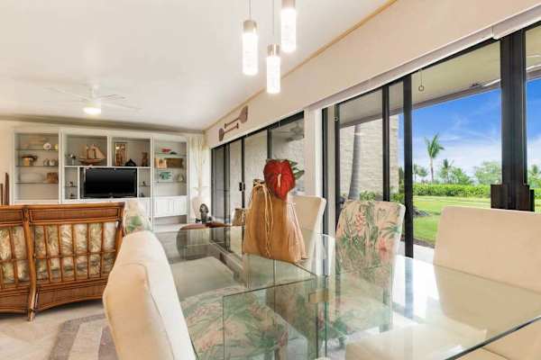 Sunlit Dining Area with Scenic Views Through Large Glass Doors