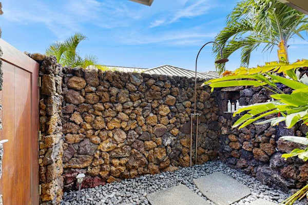 Refreshing Outdoor Shower Enclosed by Natural Lava Rock Walls