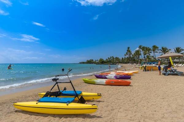 Sandy beach with colorful ocean canoes
