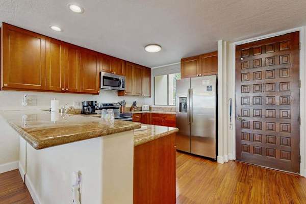 Cook with ease in the fully equipped kitchen, featuring stainless steel appliances and ample prep space
