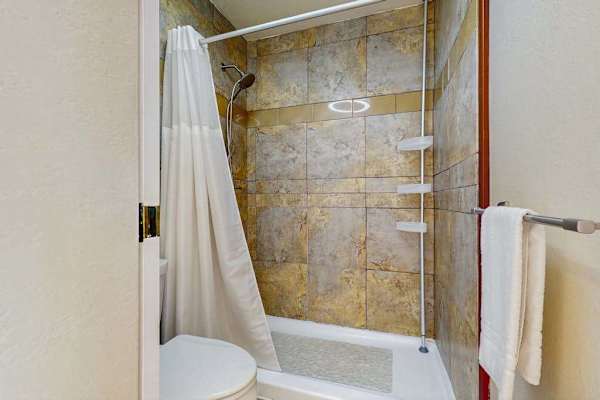 Unwind with a relaxing soak or a refreshing shower in the beautifully tiled tub-shower combo