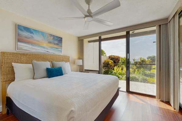 Relax in style, this airy, coastal-themed bedroom offers seamless indoor-outdoor flow
