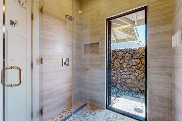 Walk-In Tile Shower with Glass Door & Access to Private Outdoor Space