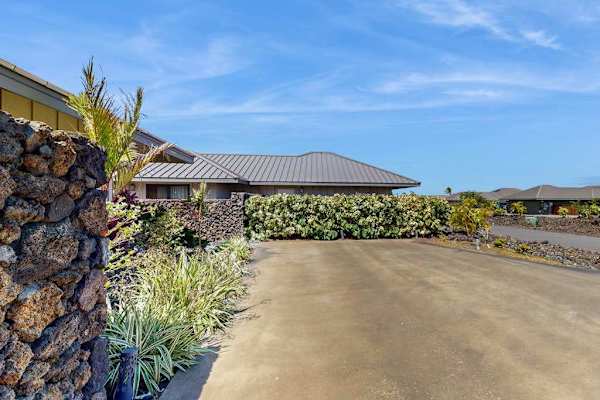 Driveway Approach & Exterior Wall with Tropical Hedging