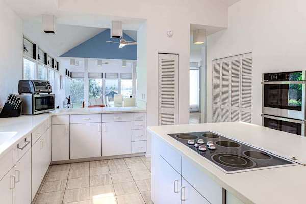 Fully equipped kitchen overlooks peaceful surroundings, creating an enjoyable cooking experience every day