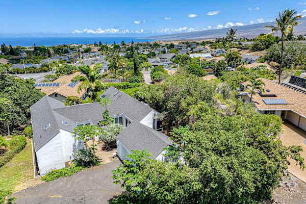 Bird's-eye view reveals charming home, scenic balcony, and breathtaking neighborhood surroundings together